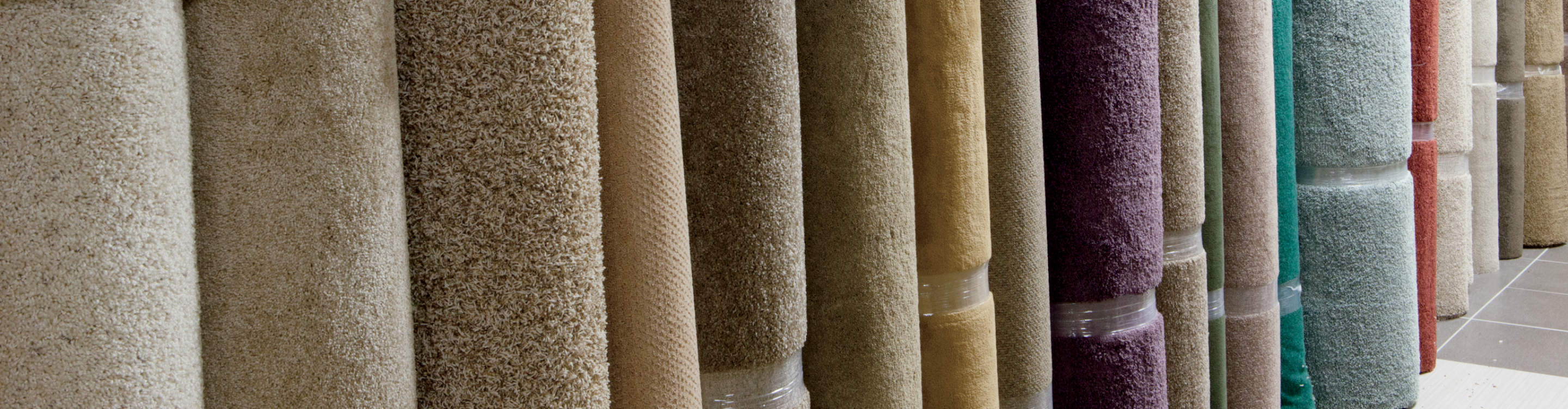 rolled up selection of carpet remnants in different colors